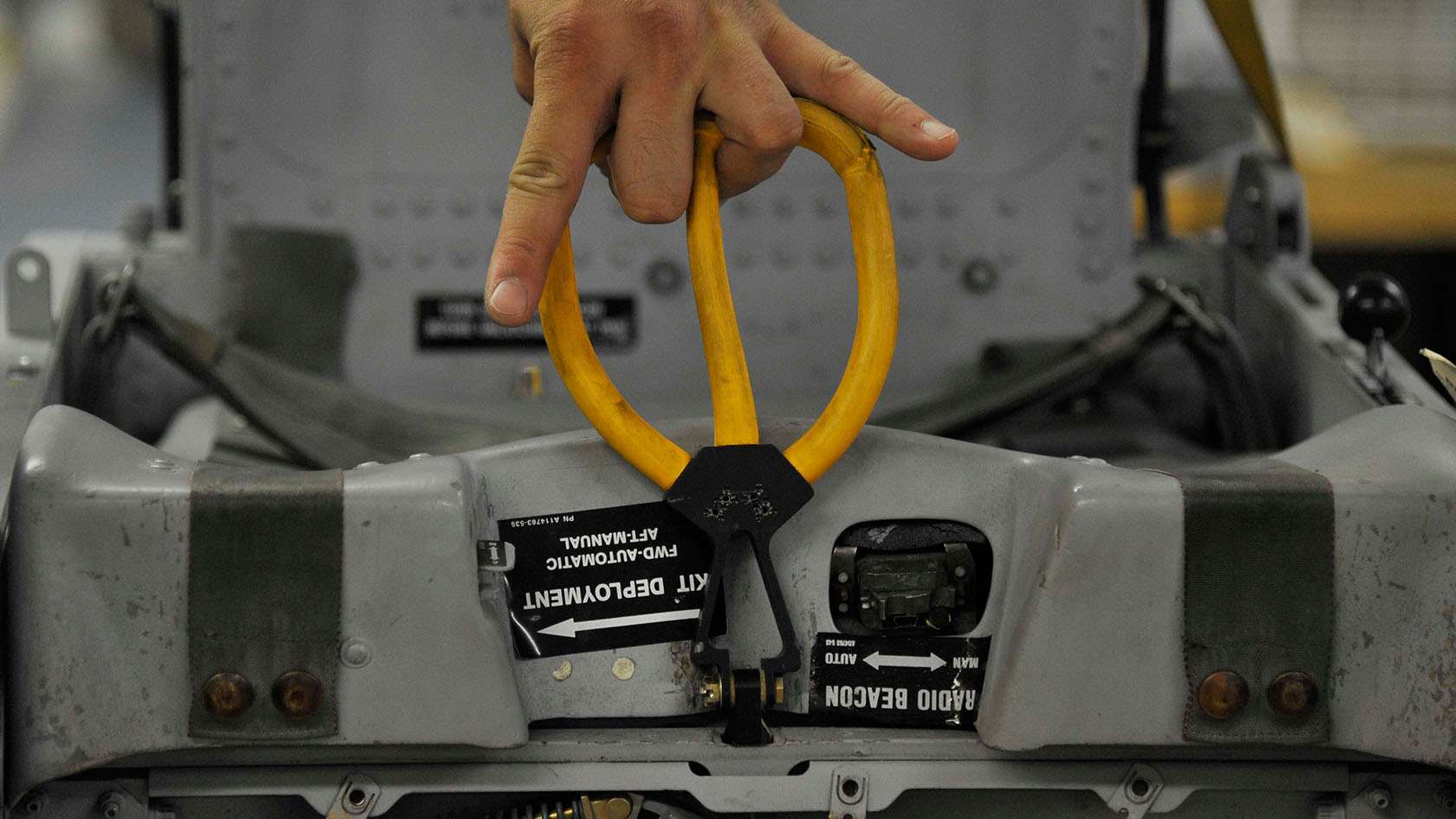 airman's hand testing aircraft's emergency deployment